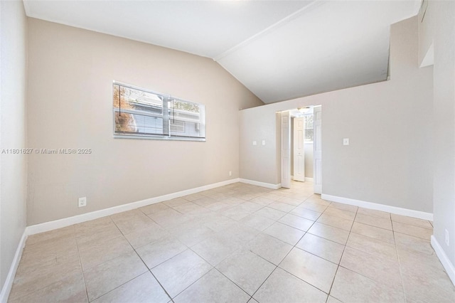 19735 NE 12th Ave, Miami, FL 33179 - unfurnished room with light tile patterned flooring, vaulted ceiling, and baseboards
