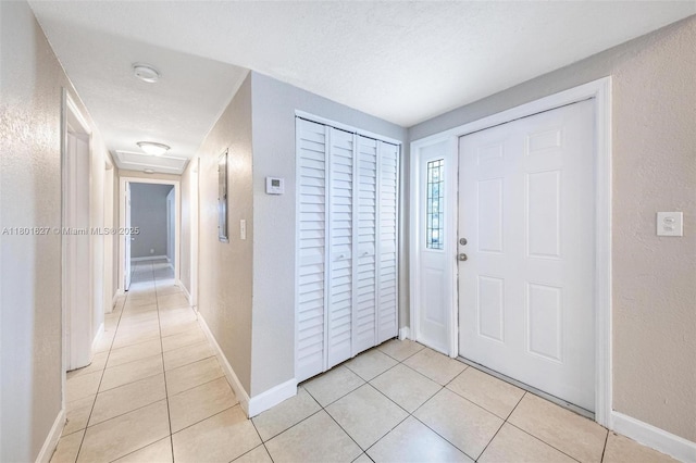 19735 NE 12th Ave, Miami, FL 33179 - entrance foyer with a textured wall, light tile patterned floors, baseboards, and a textured ceiling