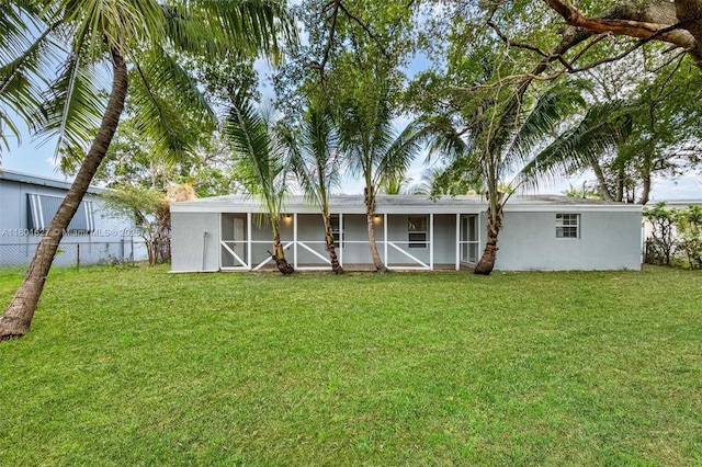 19735 NE 12th Ave, Miami, FL 33179 - rear view of house featuring a sunroom and stucco siding