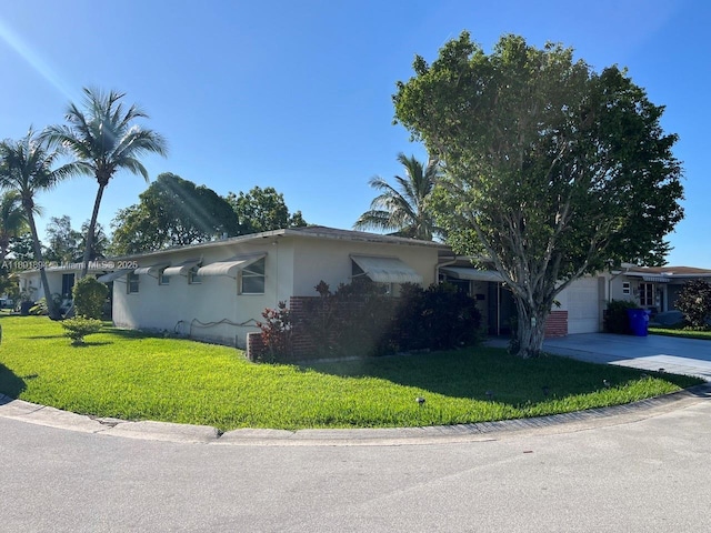 1130 NW 67th Ave, Margate, FL 33063 - view of front of property with driveway, a front yard, an attached garage, and stucco siding