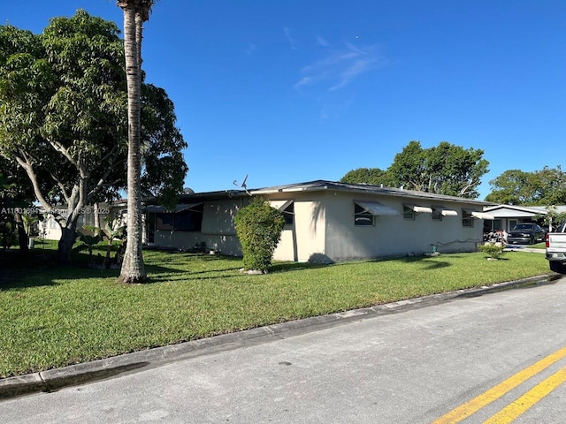 1130 NW 67th Ave, Margate, FL 33063 - view of side of property with a lawn and stucco siding