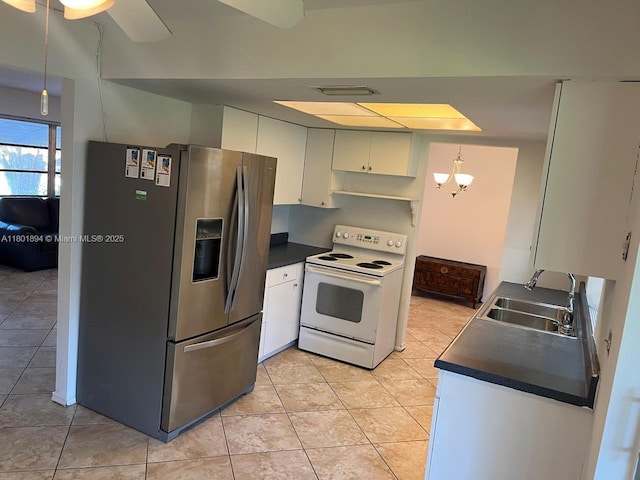 1130 NW 67th Ave, Margate, FL 33063 - kitchen with white electric range, stainless steel fridge, dark countertops, and a sink