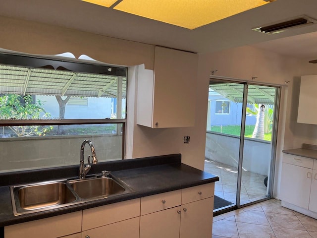 1130 NW 67th Ave, Margate, FL 33063 - kitchen with a sink, white cabinets, and plenty of natural light