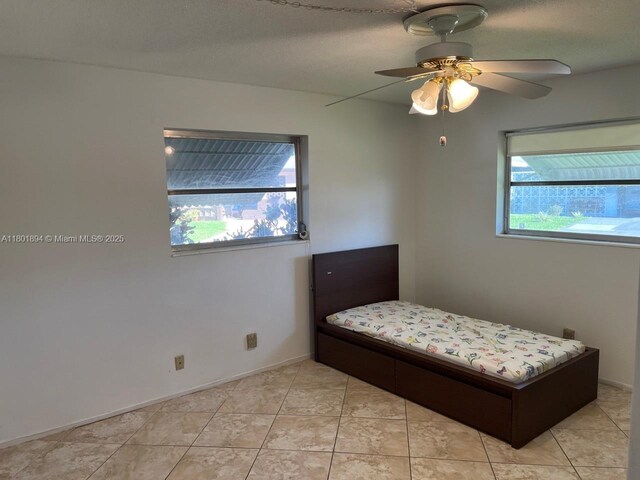 1130 NW 67th Ave, Margate, FL 33063 - bedroom featuring ceiling fan, light tile patterned floors, and baseboards
