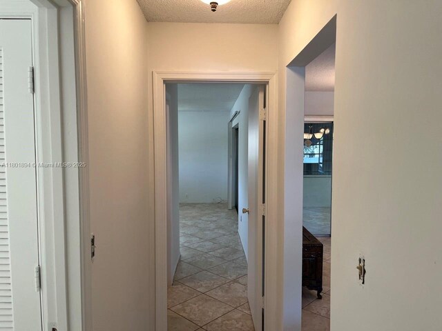 1130 NW 67th Ave, Margate, FL 33063 - hall featuring tile patterned flooring and a textured ceiling