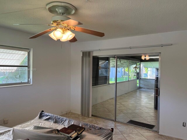 1130 NW 67th Ave, Margate, FL 33063 - spare room with a textured ceiling, a ceiling fan, and light tile patterned flooring