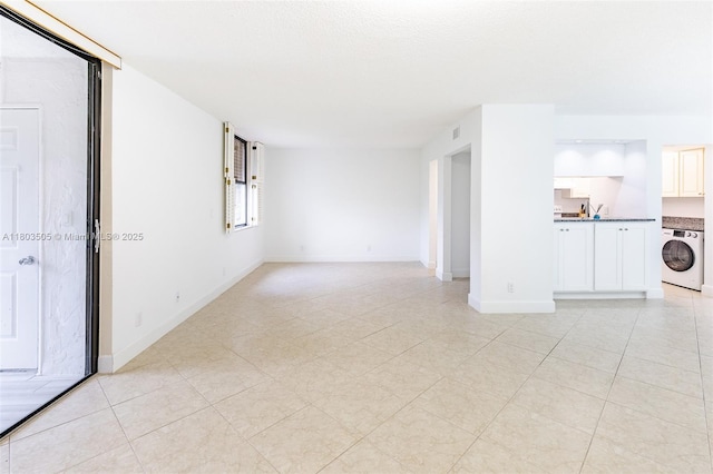 3490 N Key Dr Unit 106, Fort Myers, FL 33903 - empty room featuring washer / dryer and baseboards