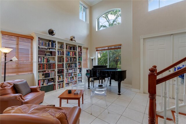 9248 SW 209th Ter, Cutler Bay, FL 33189 - sitting room with light tile patterned floors, a towering ceiling, stairs, baseboards, and ornamental molding