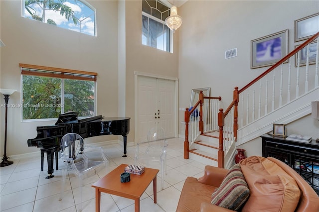 9248 SW 209th Ter, Cutler Bay, FL 33189 - foyer featuring a towering ceiling, stairs, light tile patterned flooring, and baseboards