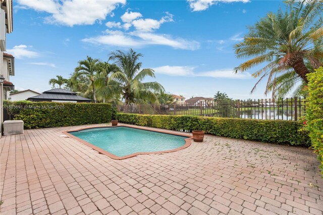 9248 SW 209th Ter, Cutler Bay, FL 33189 - view of swimming pool featuring a patio area, a fenced backyard, and a water view
