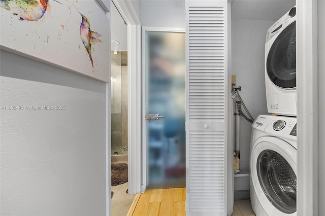 1228 W Ave Unit 704, Miami Beach, FL 33139 - clothes washing area featuring stacked washer / dryer and light wood finished floors