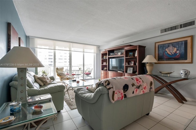 5601 Collins Ave Unit 615, Miami Beach, FL 33140 - living area featuring light tile patterned floors, a textured ceiling, and expansive windows