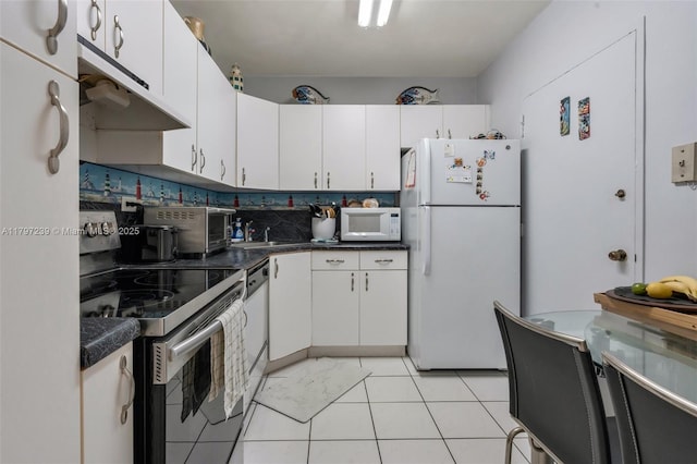 5601 Collins Ave Unit 615, Miami Beach, FL 33140 - kitchen featuring white appliances, white cabinets, and under cabinet range hood