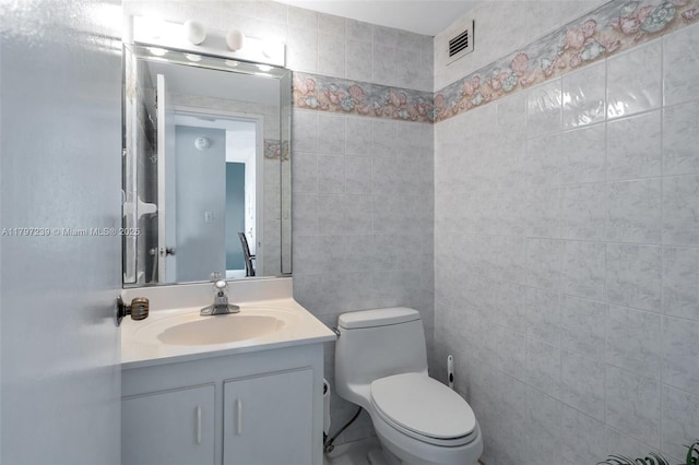 5601 Collins Ave Unit 615, Miami Beach, FL 33140 - bathroom with vanity, toilet, and tile walls