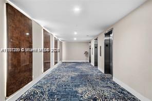 5601 Collins Ave Unit 615, Miami Beach, FL 33140 - hallway featuring baseboards, carpet flooring, and recessed lighting