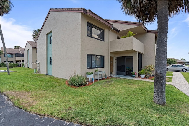 1145 N Shannon Unit 39, Indialantic, FL 32903 - view of property exterior with stucco siding and a lawn