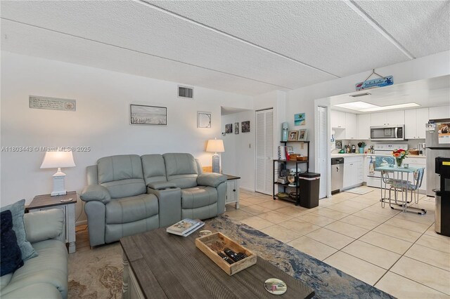1145 N Shannon Unit 39, Indialantic, FL 32903 - living area with light tile patterned flooring and a textured ceiling