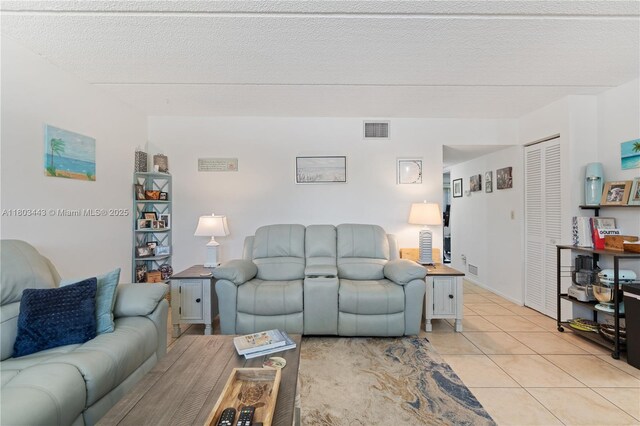 1145 N Shannon Unit 39, Indialantic, FL 32903 - living room featuring light tile patterned flooring and a textured ceiling