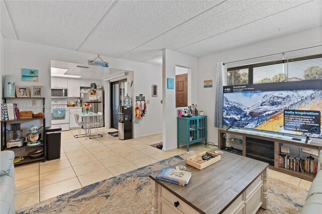 1145 N Shannon Unit 39, Indialantic, FL 32903 - living room with light tile patterned flooring and a textured ceiling