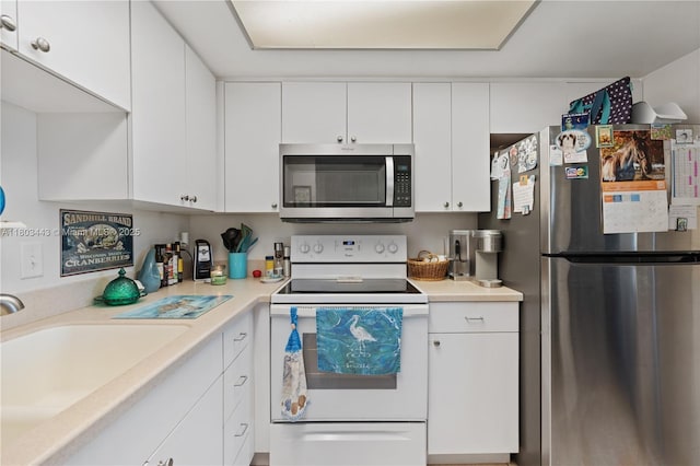 1145 N Shannon Unit 39, Indialantic, FL 32903 - kitchen with stainless steel appliances, a sink, light countertops, and white cabinetry