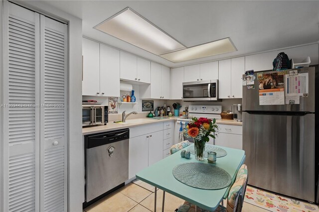 1145 N Shannon Unit 39, Indialantic, FL 32903 - kitchen with stainless steel appliances, light countertops, and white cabinets