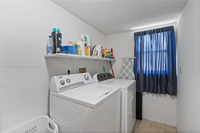 1145 N Shannon Unit 39, Indialantic, FL 32903 - laundry room with washing machine and clothes dryer, a textured ceiling, light tile patterned floors, and baseboards
