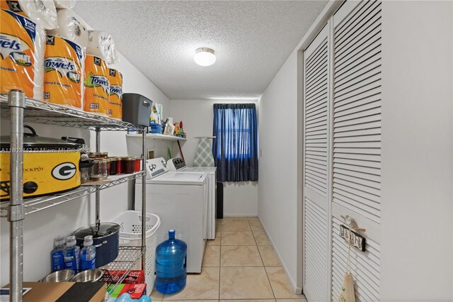 1145 N Shannon Unit 39, Indialantic, FL 32903 - laundry room with washing machine and clothes dryer, a textured ceiling, and tile patterned flooring