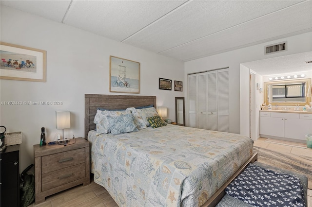1145 N Shannon Unit 39, Indialantic, FL 32903 - bedroom featuring a closet, light wood-style flooring, and ensuite bathroom