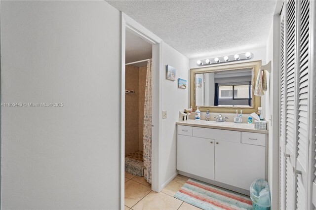 1145 N Shannon Unit 39, Indialantic, FL 32903 - full bath featuring tile patterned floors, a tile shower, vanity, a textured ceiling, and a closet