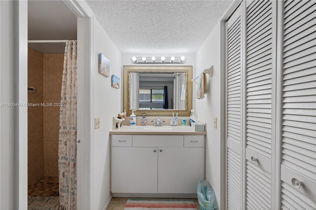 1145 N Shannon Unit 39, Indialantic, FL 32903 - full bathroom with a closet, tiled shower, vanity, tile patterned floors, and a textured ceiling
