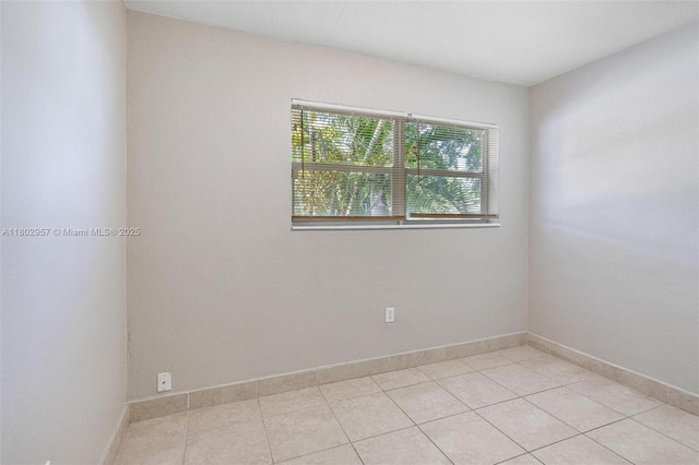 20740 NE 13th Ct, Miami, FL 33179 - unfurnished room with light tile patterned flooring and baseboards