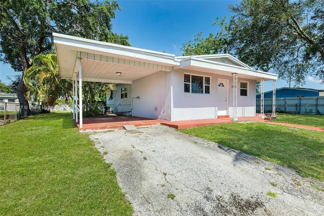 20740 NE 13th Ct, Miami, FL 33179 - view of front facade with stucco siding, driveway, and a carport
