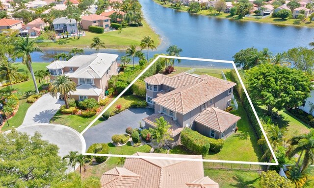 5081 NW 120th Ave, Coral Springs, FL 33076 - aerial perspective of suburban area featuring property parcel outlined and a large body of water