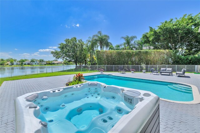 5081 NW 120th Ave, Coral Springs, FL 33076 - view of swimming pool featuring a water view, an outdoor living space, and a hot tub