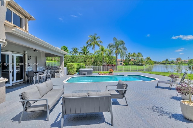 5081 NW 120th Ave, Coral Springs, FL 33076 - view of swimming pool featuring outdoor lounge area, a patio, a water view, and a fenced backyard