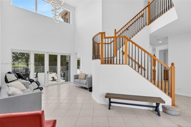 5081 NW 120th Ave, Coral Springs, FL 33076 - stairs with a high ceiling, plenty of natural light, tile patterned flooring, french doors, and a chandelier