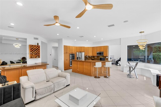 5081 NW 120th Ave, Coral Springs, FL 33076 - living area featuring ceiling fan, light tile patterned floors, and recessed lighting