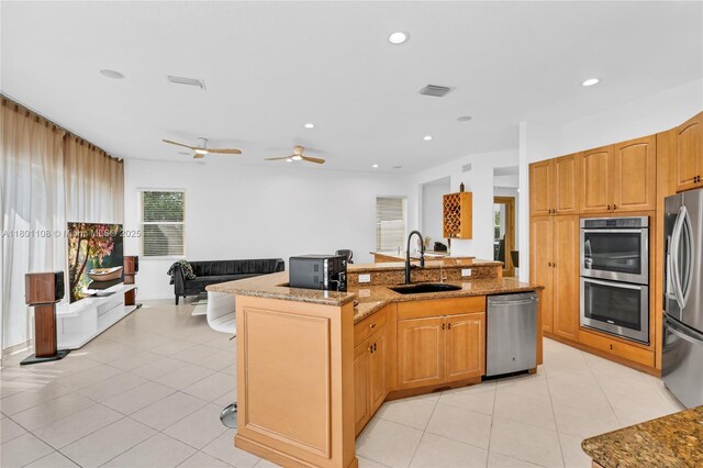 5081 NW 120th Ave, Coral Springs, FL 33076 - kitchen featuring appliances with stainless steel finishes, open floor plan, light stone counters, light tile patterned flooring, and recessed lighting