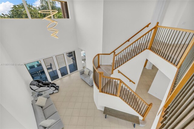 5081 NW 120th Ave, Coral Springs, FL 33076 - stairs with a towering ceiling and tile patterned flooring