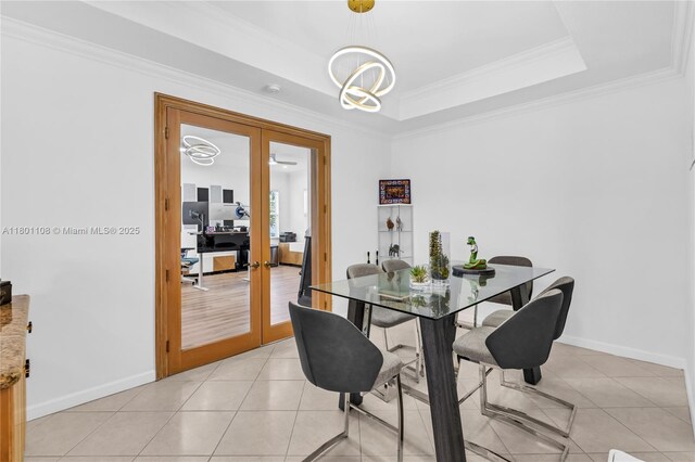 5081 NW 120th Ave, Coral Springs, FL 33076 - dining area featuring french doors, crown molding, a chandelier, light tile patterned flooring, and a raised ceiling