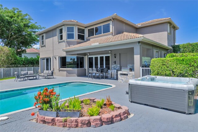 5081 NW 120th Ave, Coral Springs, FL 33076 - view of swimming pool with an outdoor living space, a hot tub, a patio area, and an outdoor kitchen