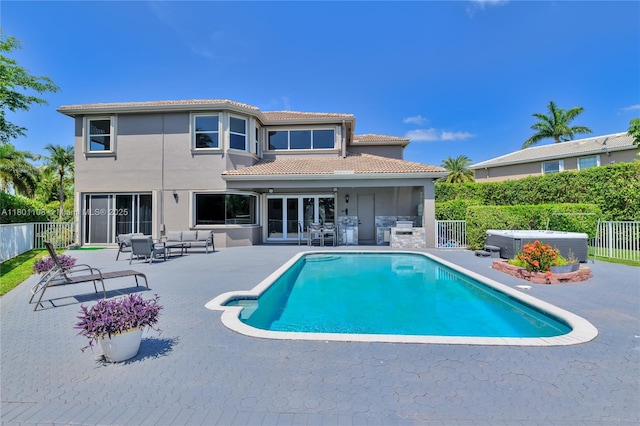 5081 NW 120th Ave, Coral Springs, FL 33076 - rear view of house featuring a hot tub, a patio, a fenced backyard, and outdoor lounge area