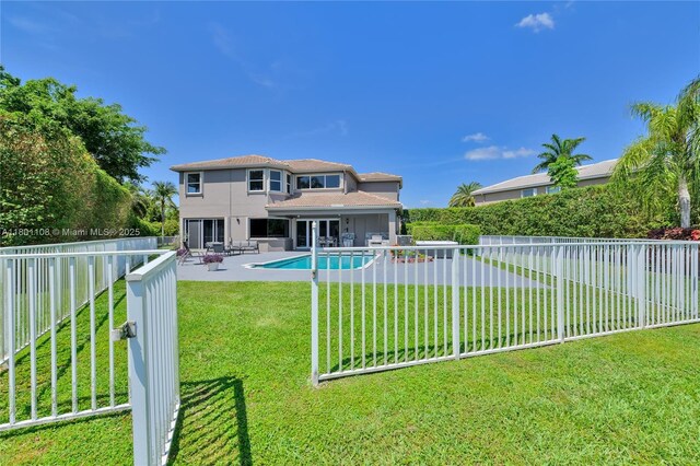 5081 NW 120th Ave, Coral Springs, FL 33076 - back of house with a fenced backyard, stucco siding, and a patio