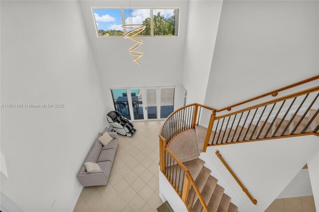 5081 NW 120th Ave, Coral Springs, FL 33076 - stairway featuring a towering ceiling and tile patterned flooring