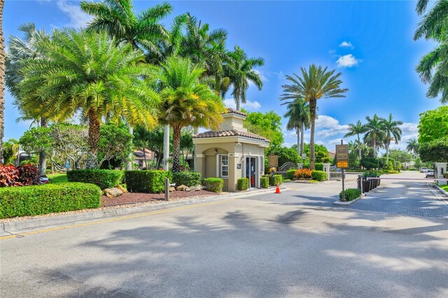 5081 NW 120th Ave, Coral Springs, FL 33076 - view of asphalt street featuring a gated entry and curbs