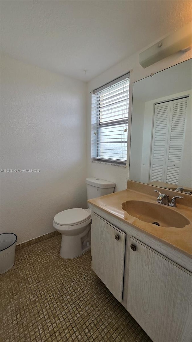 bathroom featuring toilet, vanity, and tile patterned floors