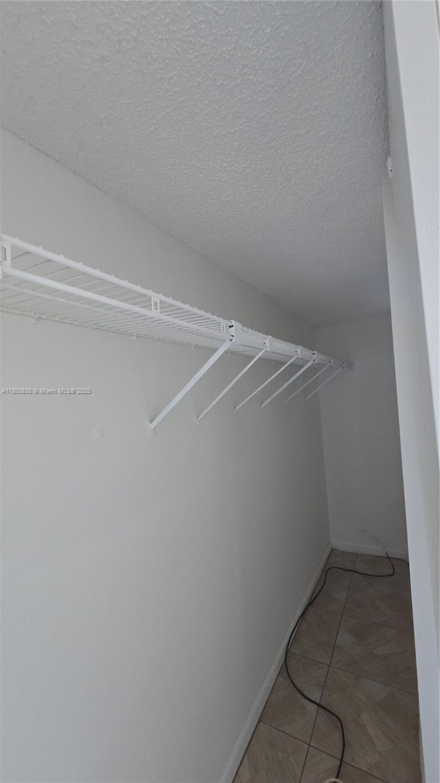 walk in closet featuring light tile patterned floors