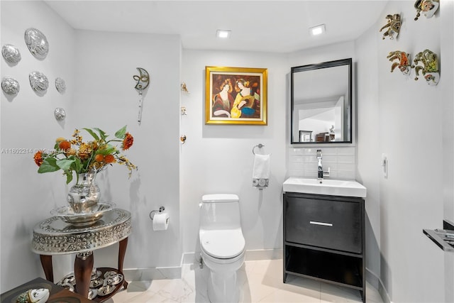 2127 Brickell Ave Unit 502, Miami, FL 33129 - bathroom featuring a sink, decorative backsplash, baseboards, toilet, and recessed lighting
