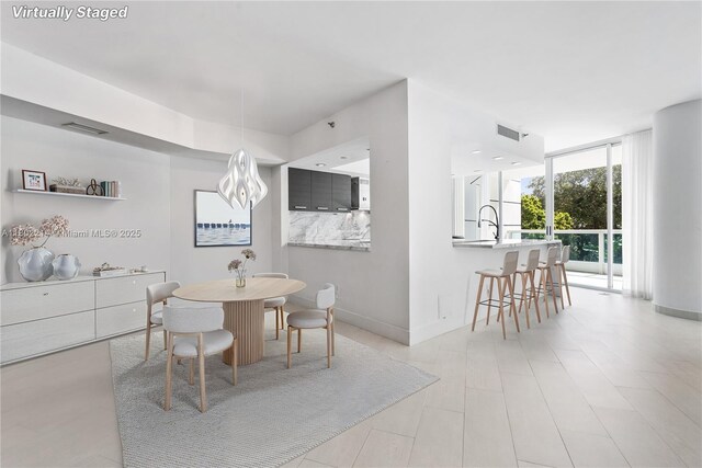 2127 Brickell Ave Unit 502, Miami, FL 33129 - dining room with a wall of windows and baseboards