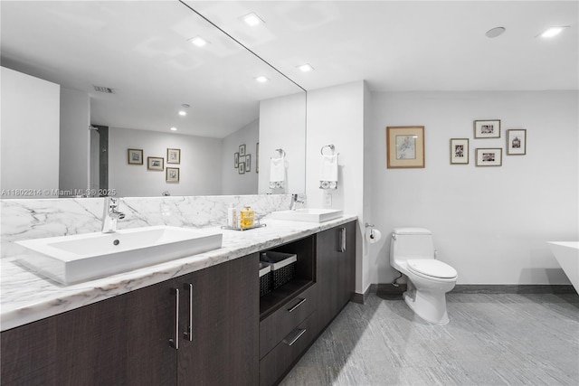 2127 Brickell Ave Unit 502, Miami, FL 33129 - full bathroom with toilet, baseboards, recessed lighting, double vanity, and a freestanding bath